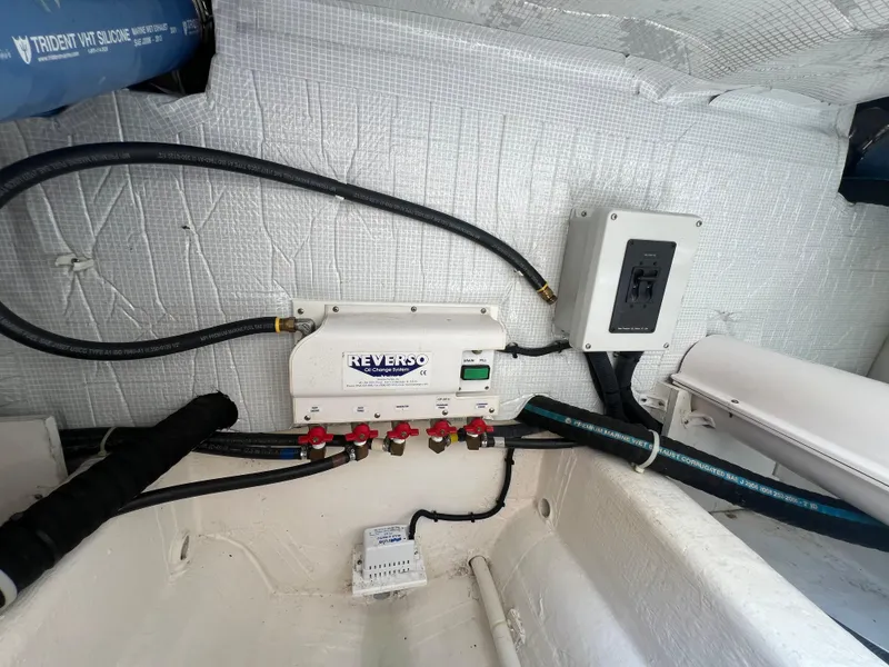 Slide: The Image of 2009 Sabre Hardtop Express engine room with Reverso oil change system and wiring. - 42