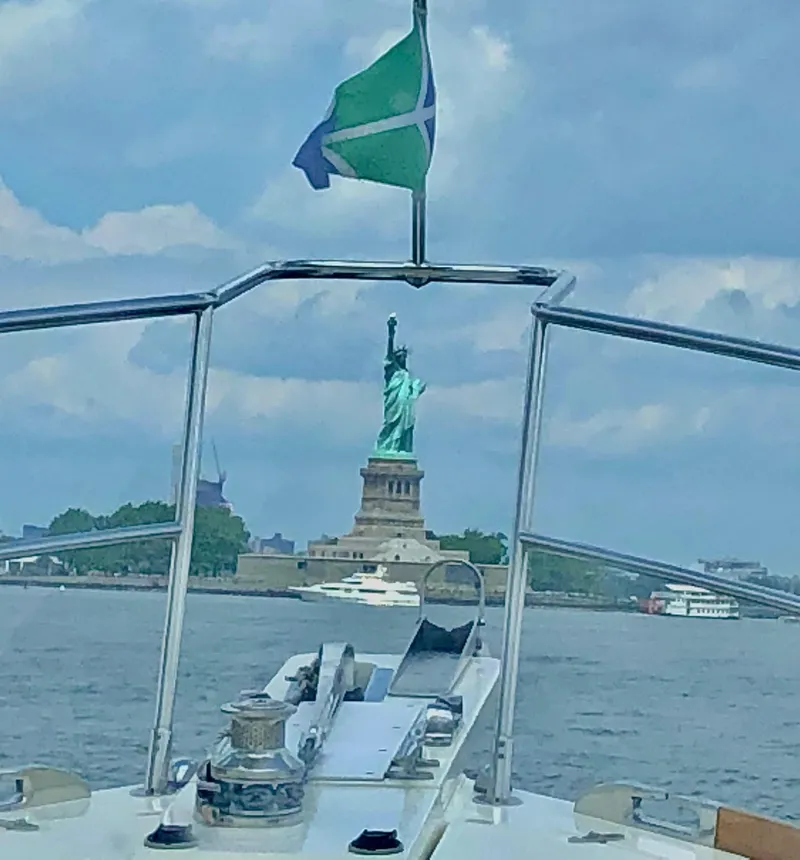 Slide: The Image of Sabre Hardtop Express 2009 boat approaching Statue of Liberty on a clear day. - 43