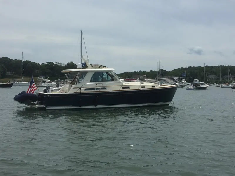 Slide: The Image of 2009 Sabre Hardtop Express boat on calm water with other boats in the background. - 44