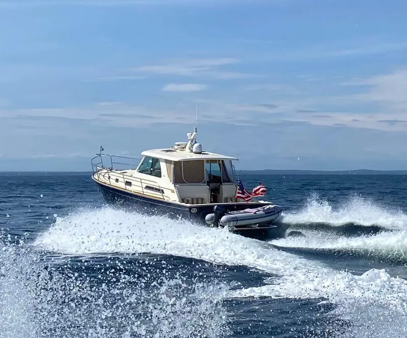 Slide: The Image of 2009 Sabre Hardtop Express cruising on open water with American flag. - 45