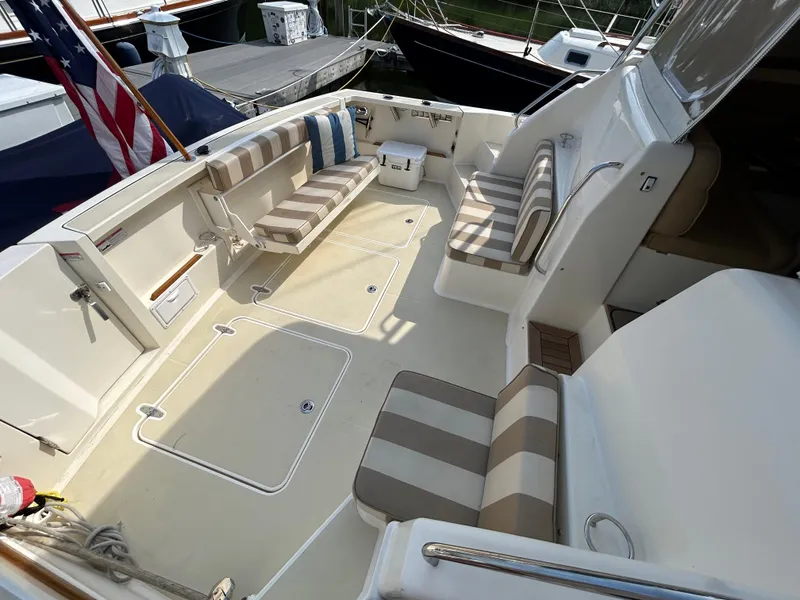 Slide: The Image of 2009 Sabre Hardtop Express boat interior with striped seating and American flag. - 6