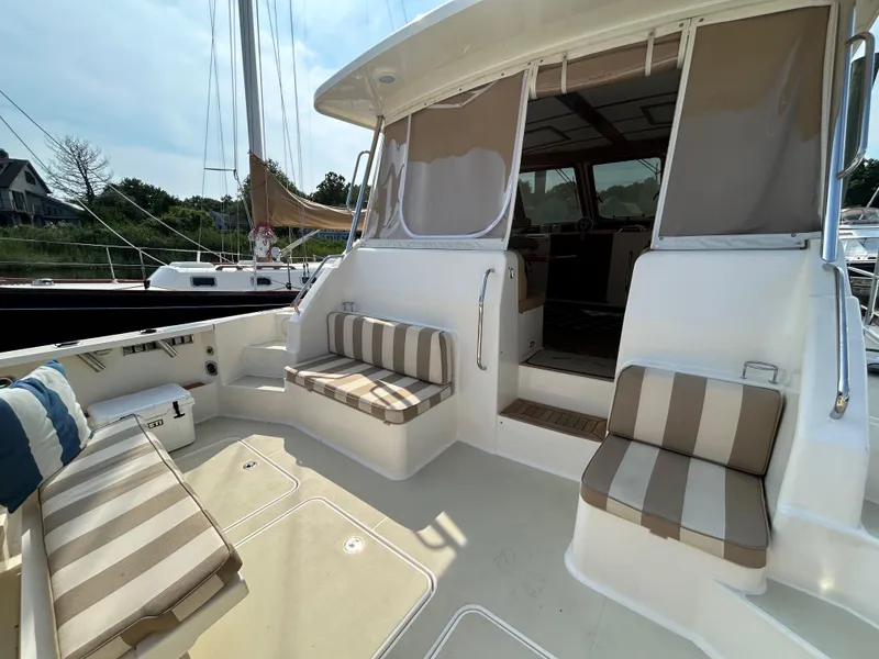 Slide: The Image of 2009 Sabre Hardtop Express boat with striped seating on deck. - 8