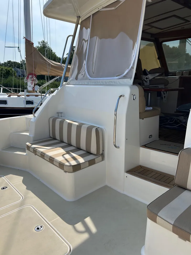 Slide: The Image of 2009 Sabre Hardtop Express yacht with striped seating and elegant interior. - 9