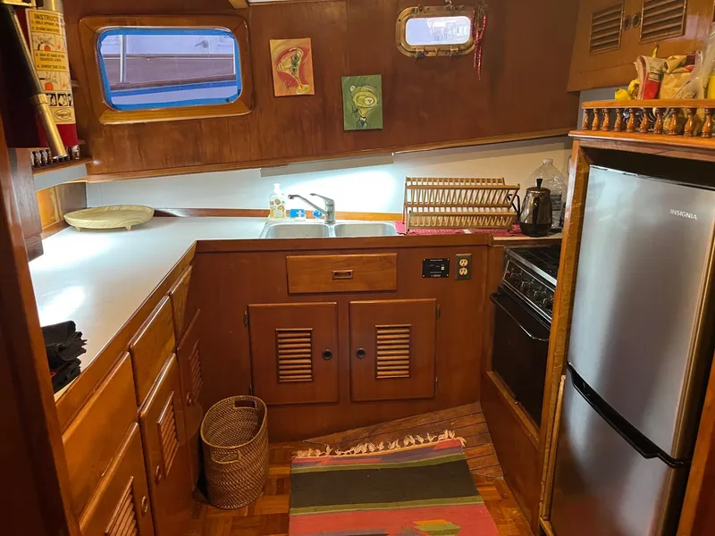 Slide: The Image of 1978 Marine Trader 44 Aft Cabin kitchen with wood cabinets and modern appliances. - 11