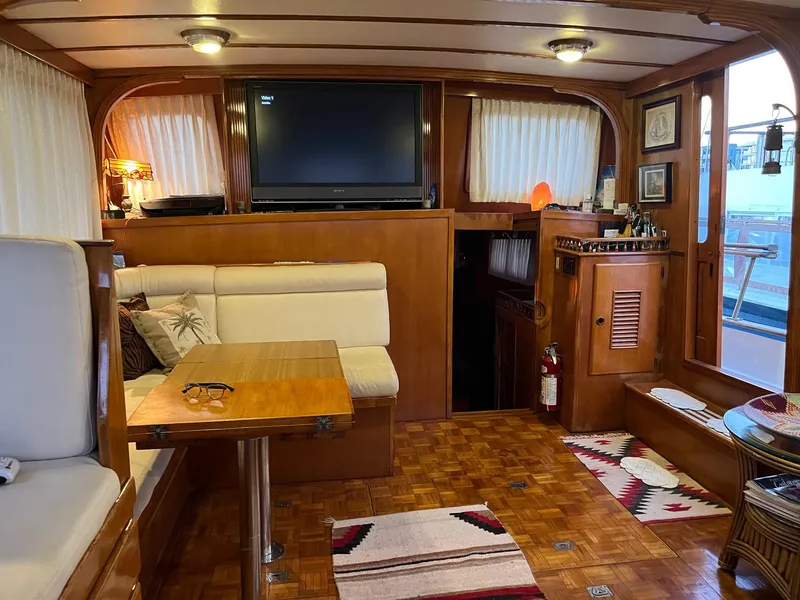 Slide: The Image of 1978 Marine Trader 44 Aft Cabin interior with cozy seating and wooden decor. - 12