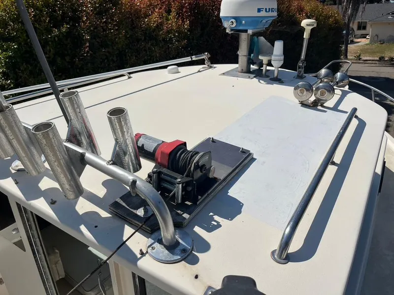 Slide: The Image of Rooftop view of a 1994 Parker 2520 boat with fishing rod holders and radar equipment. - 17