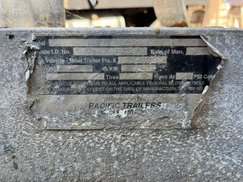 Slide: The Image of A weathered label on a 1994 Parker 2520 boat trailer by Pacific Trailers. - 21