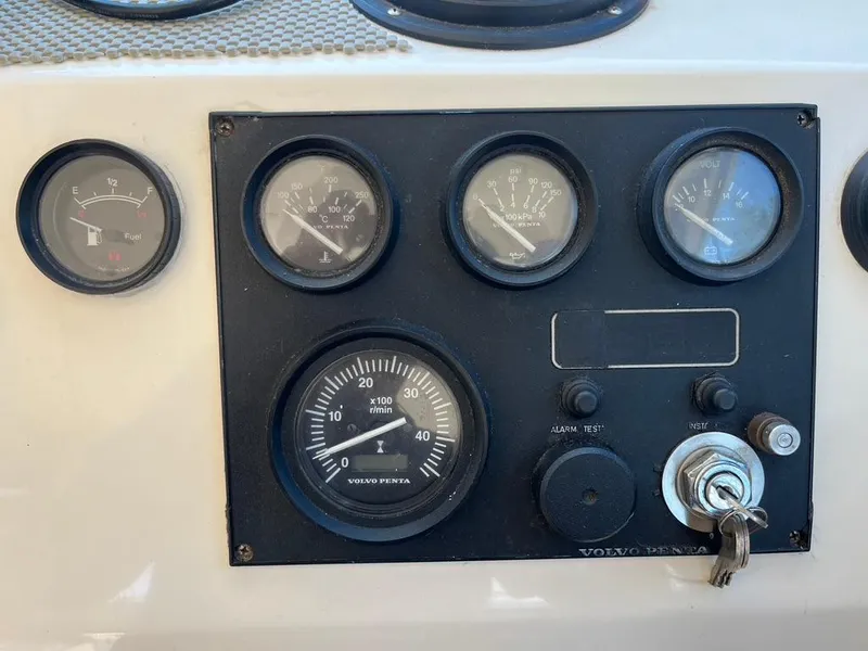 Slide: The Image of Dashboard of a 1994 Parker 2520 boat with Volvo Penta gauges and ignition key. - 27