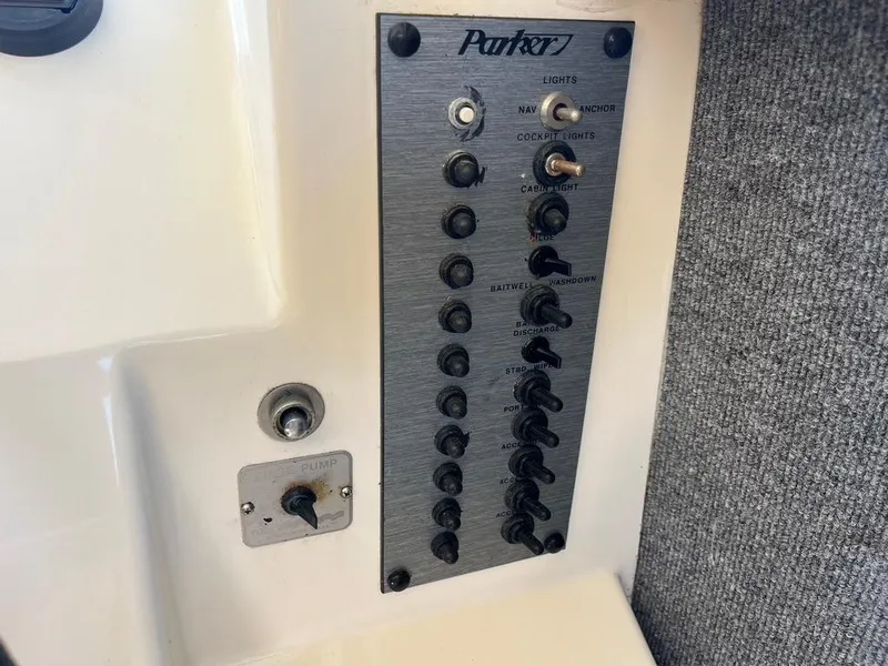 Slide: The Image of Control panel of a 1994 Parker 2520 boat with switches and labels. - 31