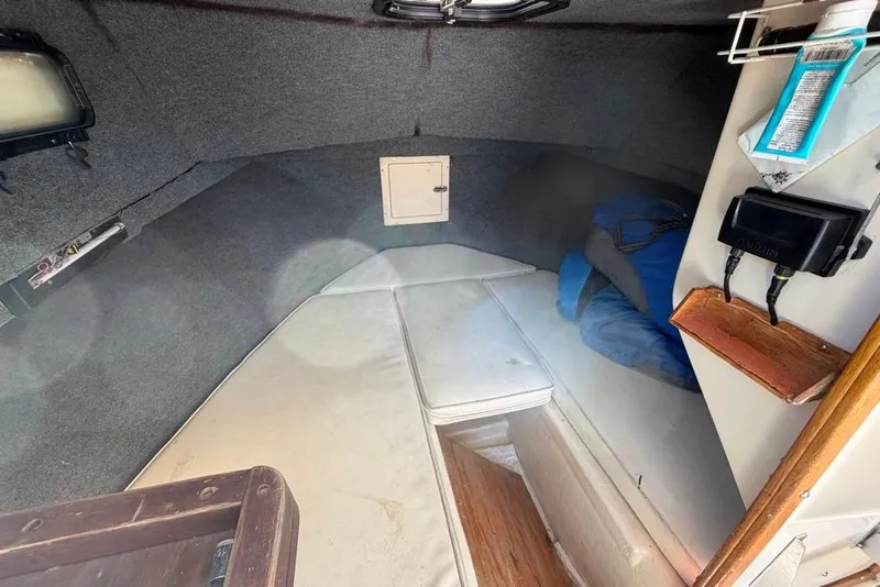 Slide: The Image of Interior cabin of a 1994 Parker 2520 boat with cushions and storage. - 34