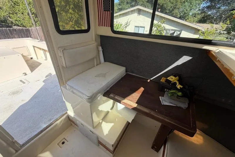 Slide: The Image of Interior of a 1994 Parker 2520 boat with seating and a small table. - 35