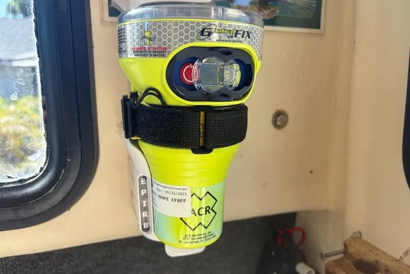 Slide: The Image of Emergency beacon mounted inside a 1994 Parker 2520 boat, near a window. - 42