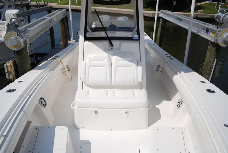 Slide: The Image of 2021 Regulator 31 boat interior with speakers and canopy, docked outdoors. - 16