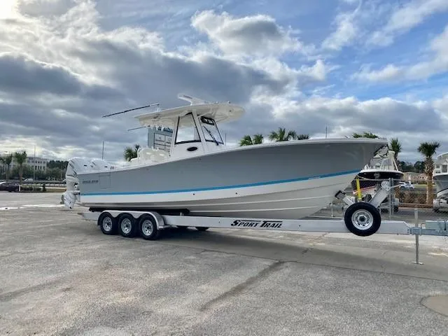 Slide: The Image of 2021 Regulator 31 boat with white deck and storage compartments. - 24