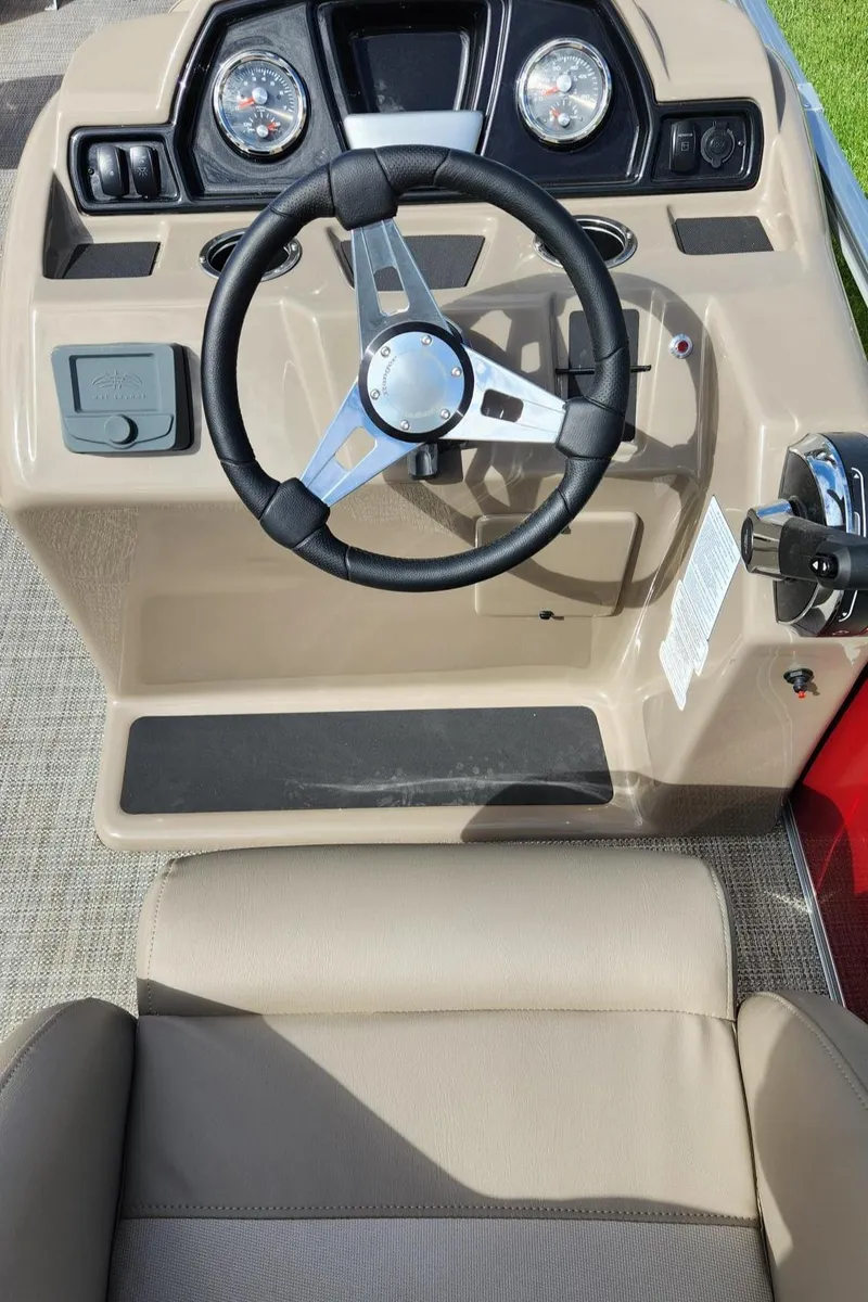 Slide: The Image of 2024 Ranger Reata 200F boat dashboard with steering wheel and controls. - 6