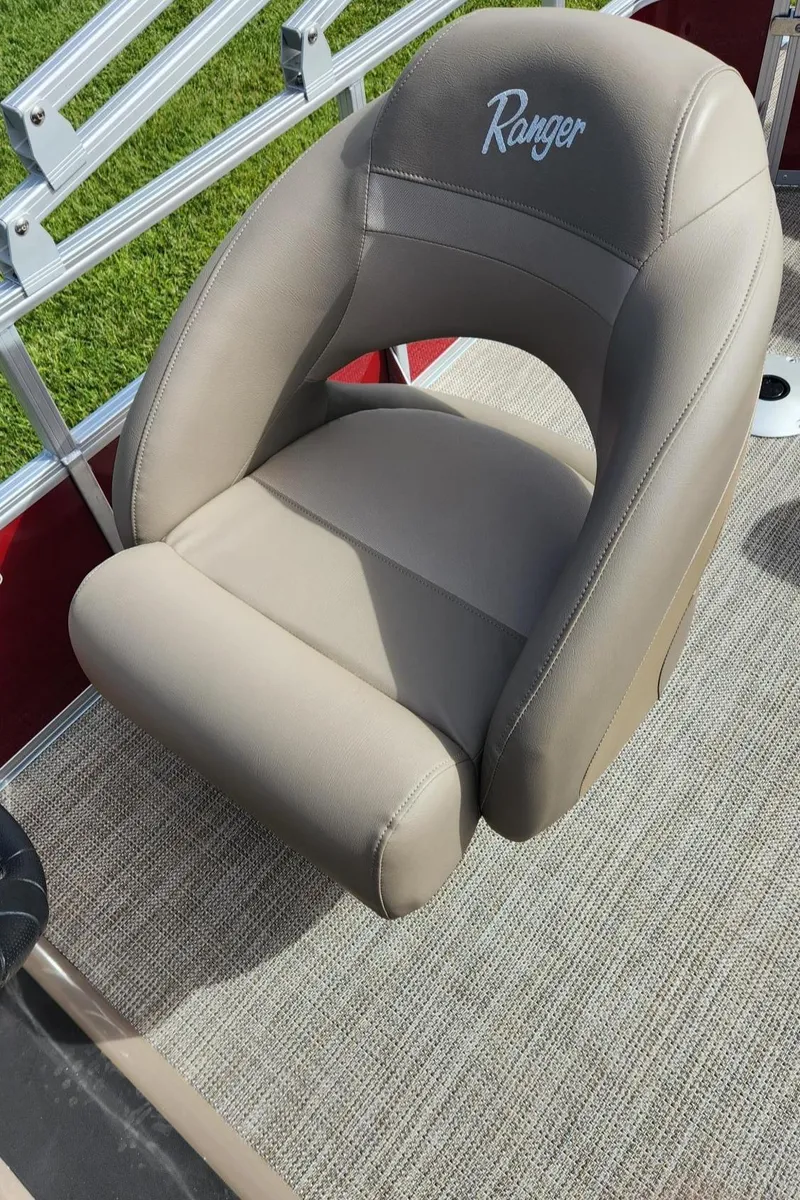 Slide: The Image of 2024 Ranger Reata 200F boat seat, beige upholstery, on deck. - 7