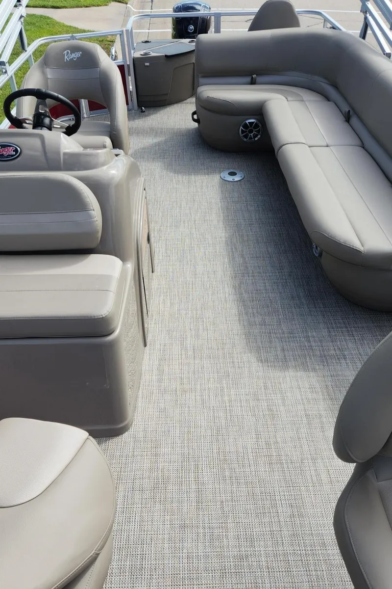 Slide: The Image of 2024 Ranger Reata 200F boat interior with gray seating and carpet flooring. - 8