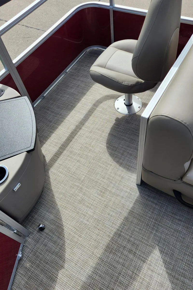 Slide: The Image of 2024 Ranger Reata 200F boat interior with beige seating and carpet flooring. - 9