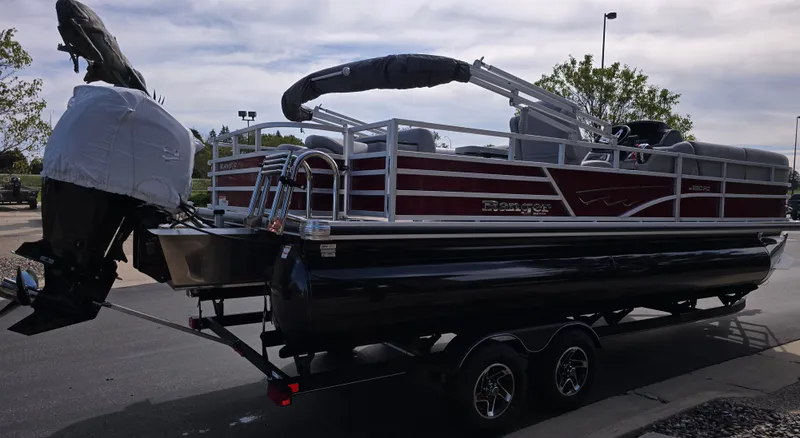 Slide: The Image of 2024 Ranger Reata 200C boat interior with beige seating and spacious layout. - 2