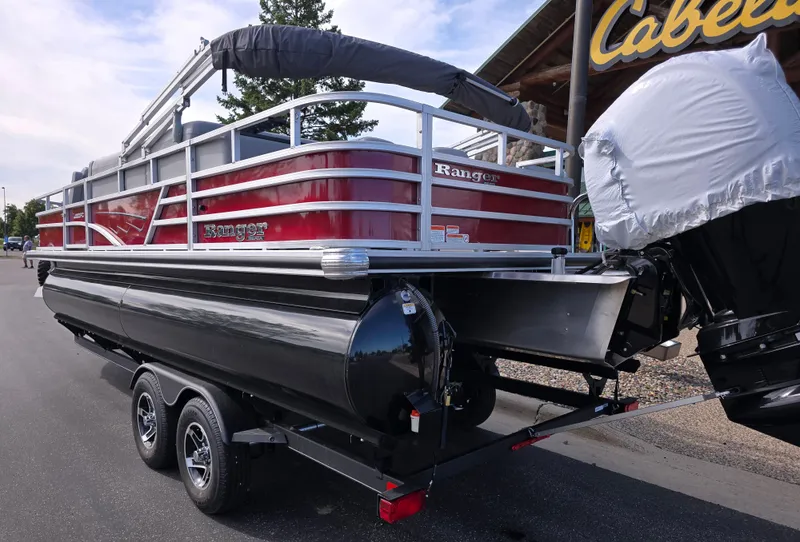 Slide: The Image of 2024 Ranger Reata 200C boat interior with beige seating and steering console. - 3