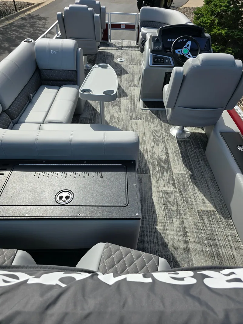 Slide: The Image of 2024 Ranger Reata 200C pontoon boat with Mercury outboard motor on trailer. - 4