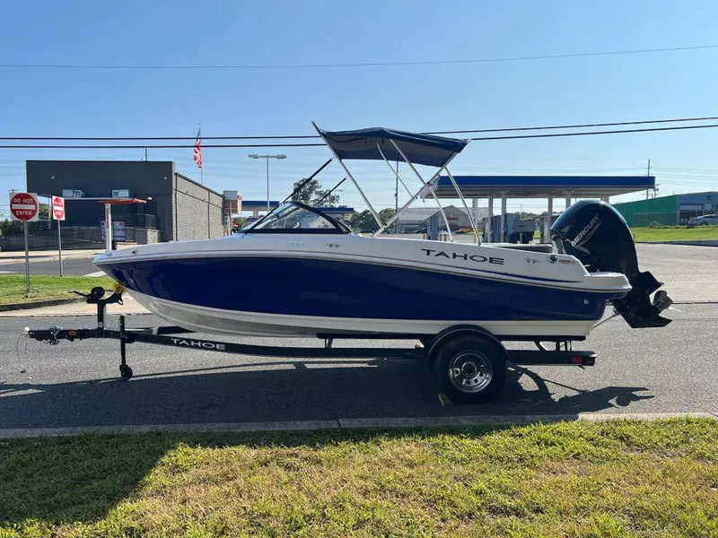 Slide: The Image of 2024 Tahoe 200 S boat on trailer, parked outdoors, side view. - 1