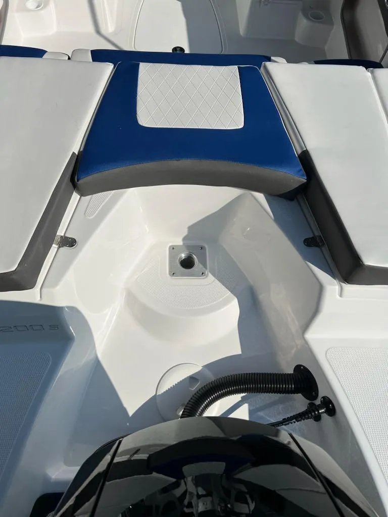 Slide: The Image of 2024 Tahoe 200 S boat interior with blue and white seating. - 11