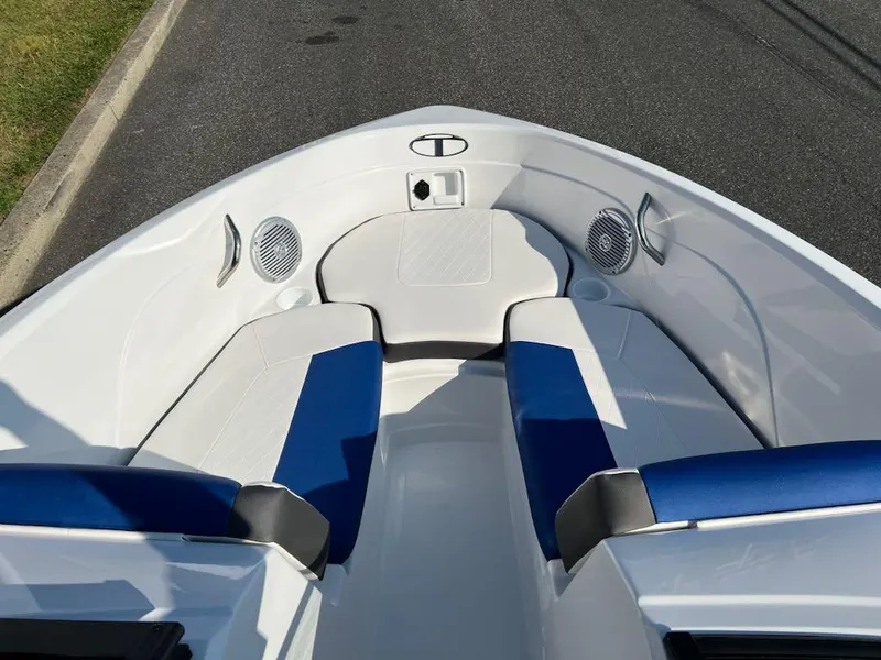Slide: The Image of 2024 Tahoe 200 S boat interior with blue and white seating, speakers, and storage compartment. - 4