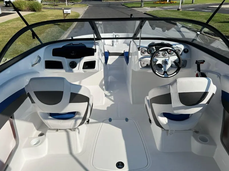 Slide: The Image of 2024 Tahoe 200 S boat interior with steering wheel and seating. - 8