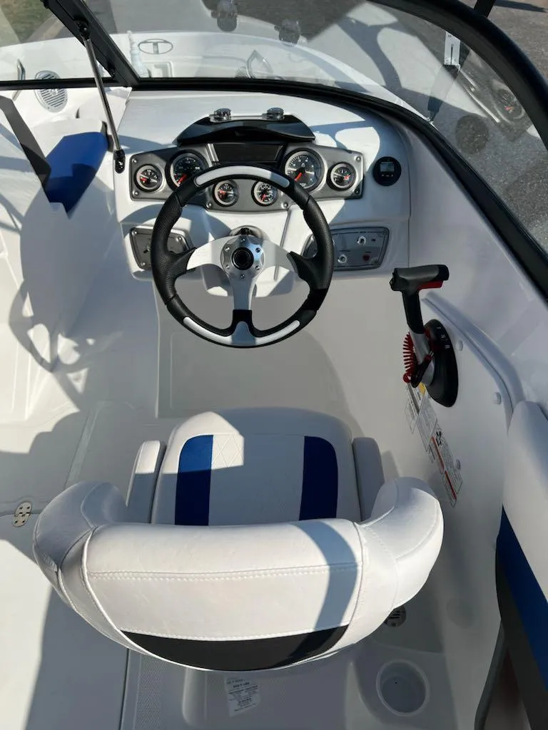 Slide: The Image of 2024 Tahoe 200 S boat cockpit with steering wheel and dashboard controls. - 9
