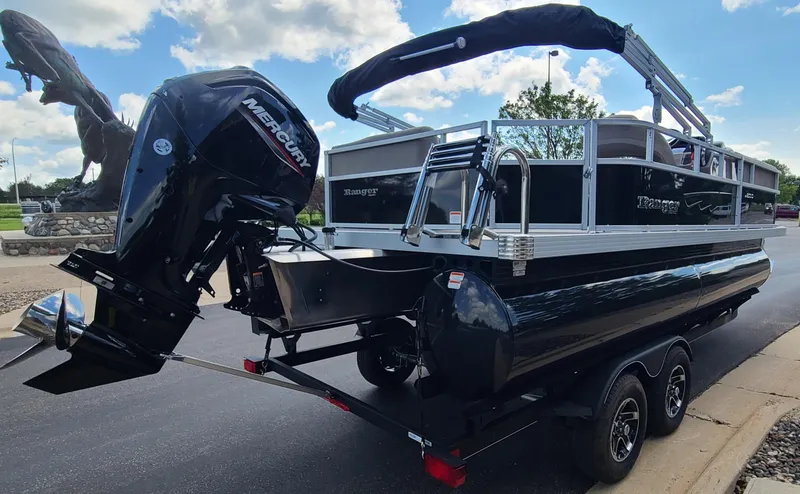 Slide: The Image of 2024 Ranger Reata 200C pontoon boat with Mercury outboard engine on trailer. - 3