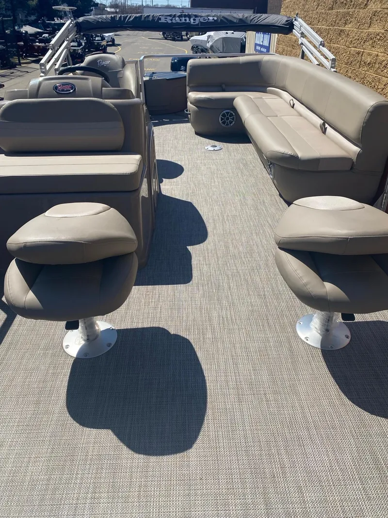 Slide: The Image of 2024 Ranger Reata 200F boat interior with beige seating and carpeted floor. - 3
