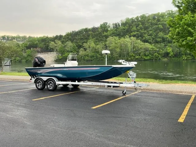 Slide: The Image of 2024 Ranger RB200 boat on trailer by a scenic river, surrounded by lush greenery. - 1