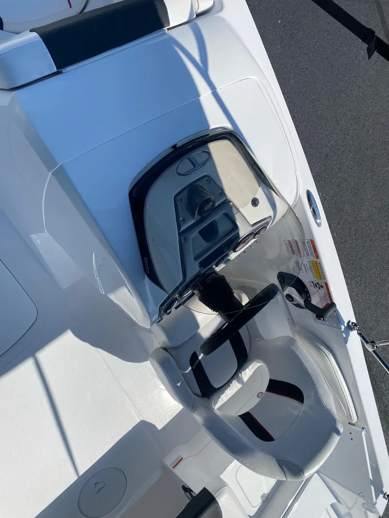 Slide: The Image of 2024 Tahoe 2150 boat interior with steering wheel and seating. - 10