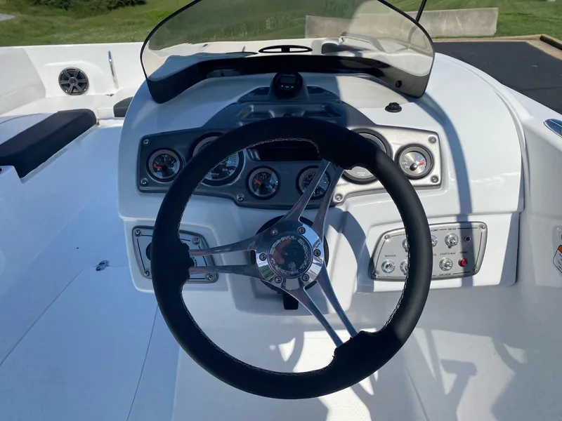 Slide: The Image of 2024 Tahoe 2150 boat dashboard with steering wheel and gauges. - 5