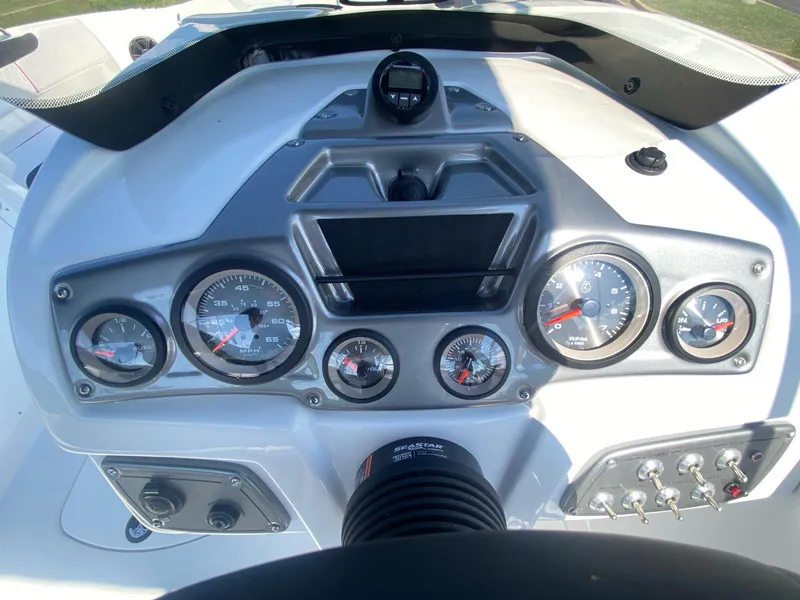 Slide: The Image of 2024 Tahoe 2150 boat dashboard with gauges and controls. - 7
