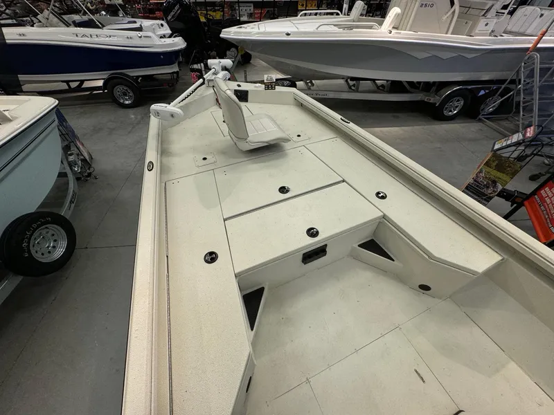 Slide: The Image of 2024 Ranger RB210 boat interior at a showroom, featuring spacious deck and seating. - 9