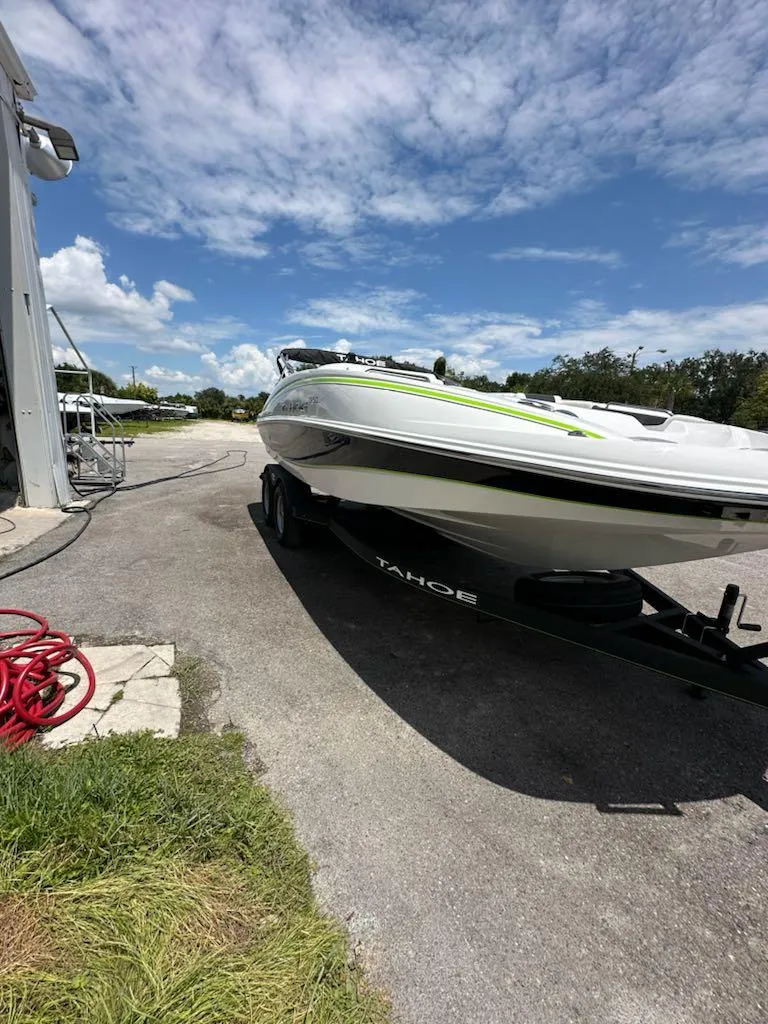Slide: The Image of 2024 Tahoe 1950 boat on trailer under clear blue sky. - 6