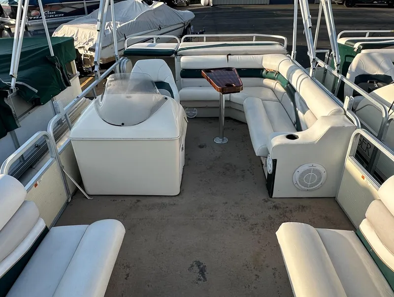 Slide: The Image of 1999 Suncruiser Trinidad 200 pontoon boat interior with white seating and a central table. - 15