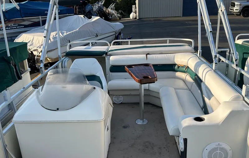 Slide: The Image of 1999 Suncruiser Trinidad 200 pontoon boat with spacious seating and a central table. - 16