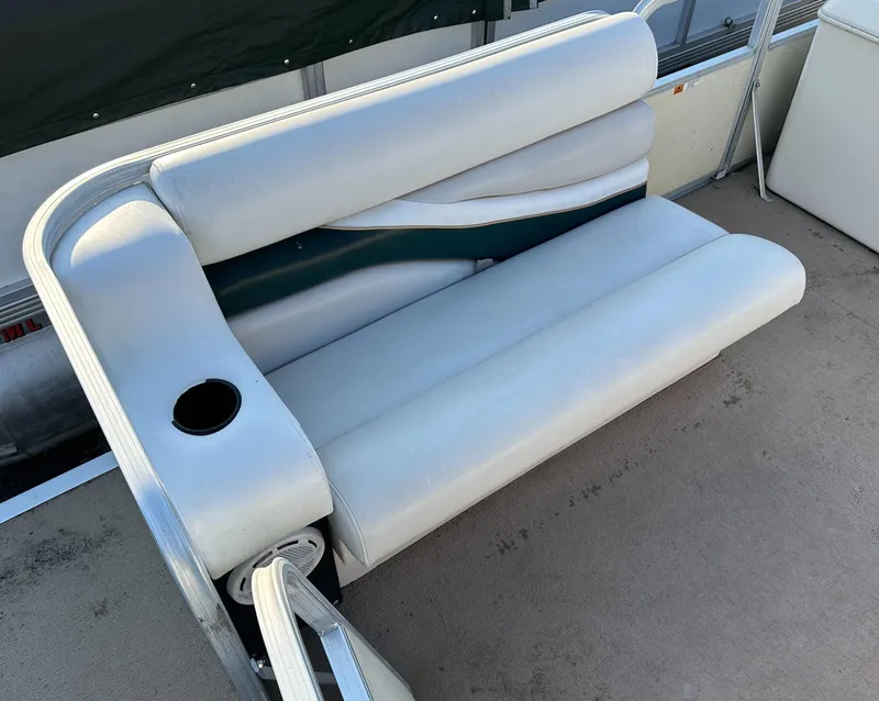 Slide: The Image of White cushioned seat on 1999 Suncruiser Trinidad 200 boat with cup holder. - 6