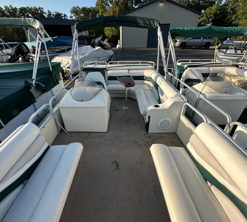 Slide: The Image of 1999 Suncruiser Trinidad 200 pontoon boat with spacious seating and green canopy. - 8