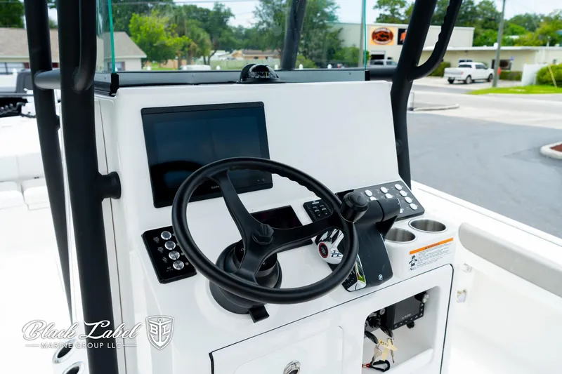 Slide: The Image of 2025 Caymas 281 HB boat dashboard with steering wheel and electronic controls. - 14