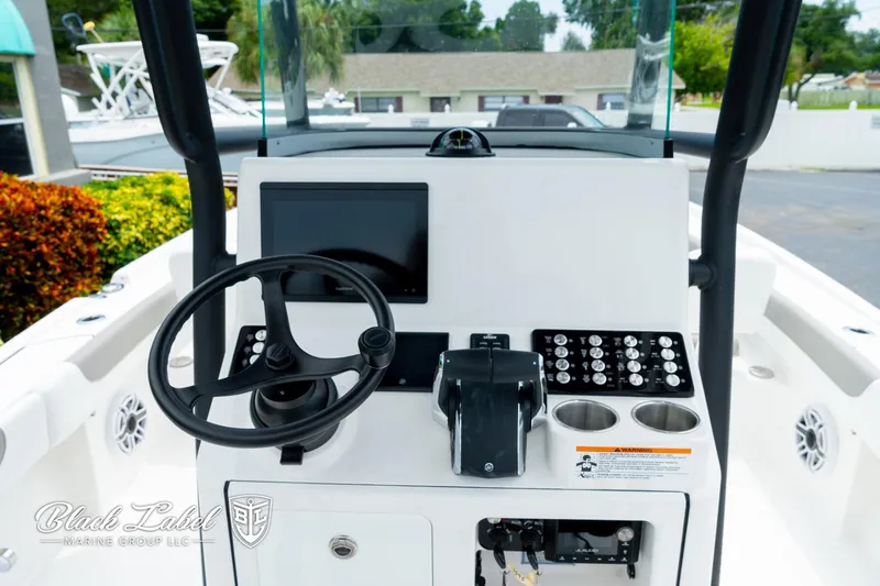 Slide: The Image of 2025 Caymas 281 HB boat dashboard with steering wheel, controls, and display screen. - 15