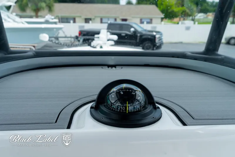 Slide: The Image of Compass on 2025 Caymas 281 HB boat dashboard, Black Label Marine Group logo visible. - 16