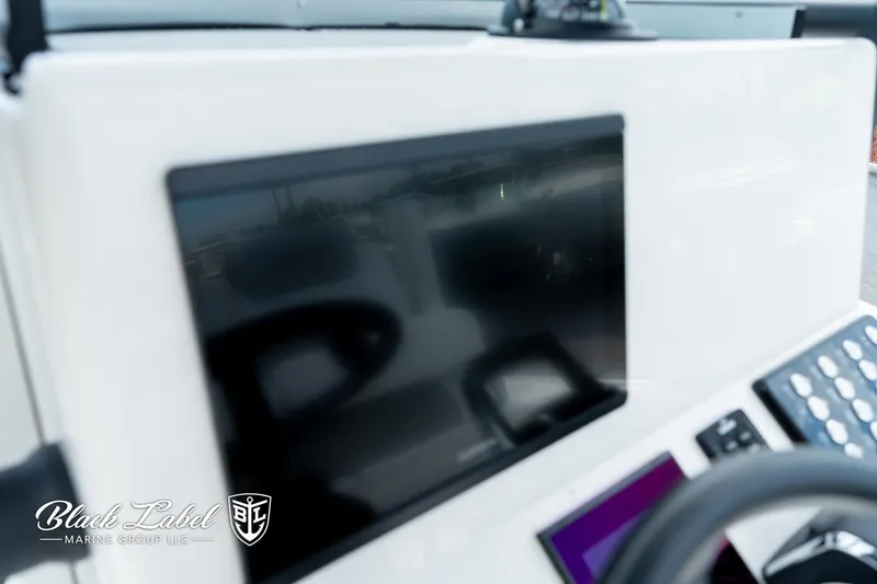 Slide: The Image of Dashboard of 2025 Caymas 281 HB boat with digital display and controls. - 19