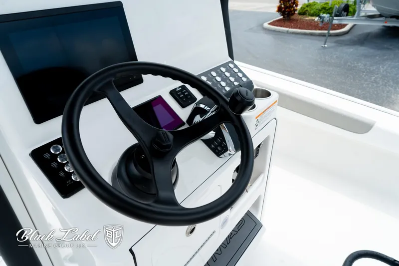 Slide: The Image of Steering console of 2025 Caymas 281 HB boat with modern controls and displays. - 23