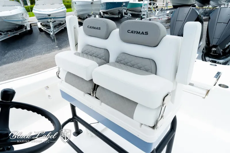 Slide: The Image of 2025 Caymas 281 HB boat seating with dual cushioned seats and steering wheel. - 24