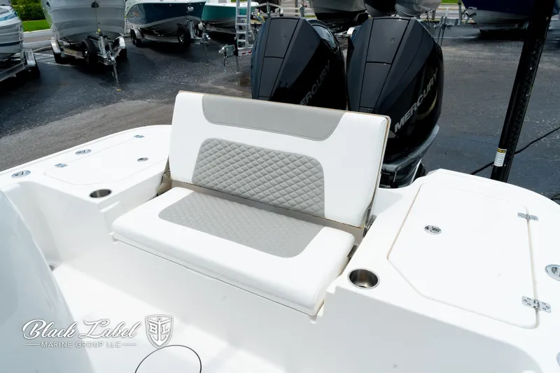 Slide: The Image of 2025 Caymas 281 HB boat with cushioned seating and dual outboard motors. - 26
