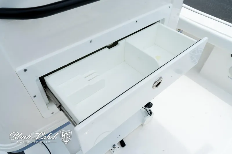 Slide: The Image of Open storage compartment on 2025 Caymas 281 HB boat. - 29